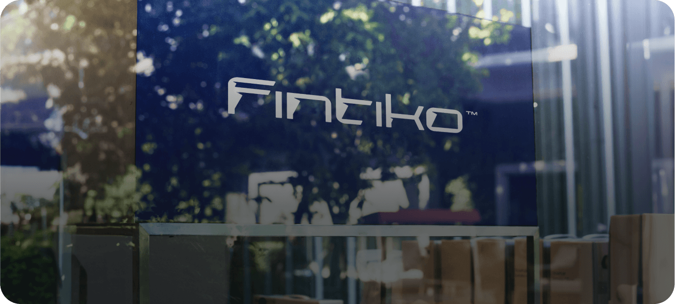 A glass window with the Fintiko logo reflected.
